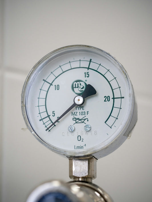 A close up of a pressure gauge on a wall