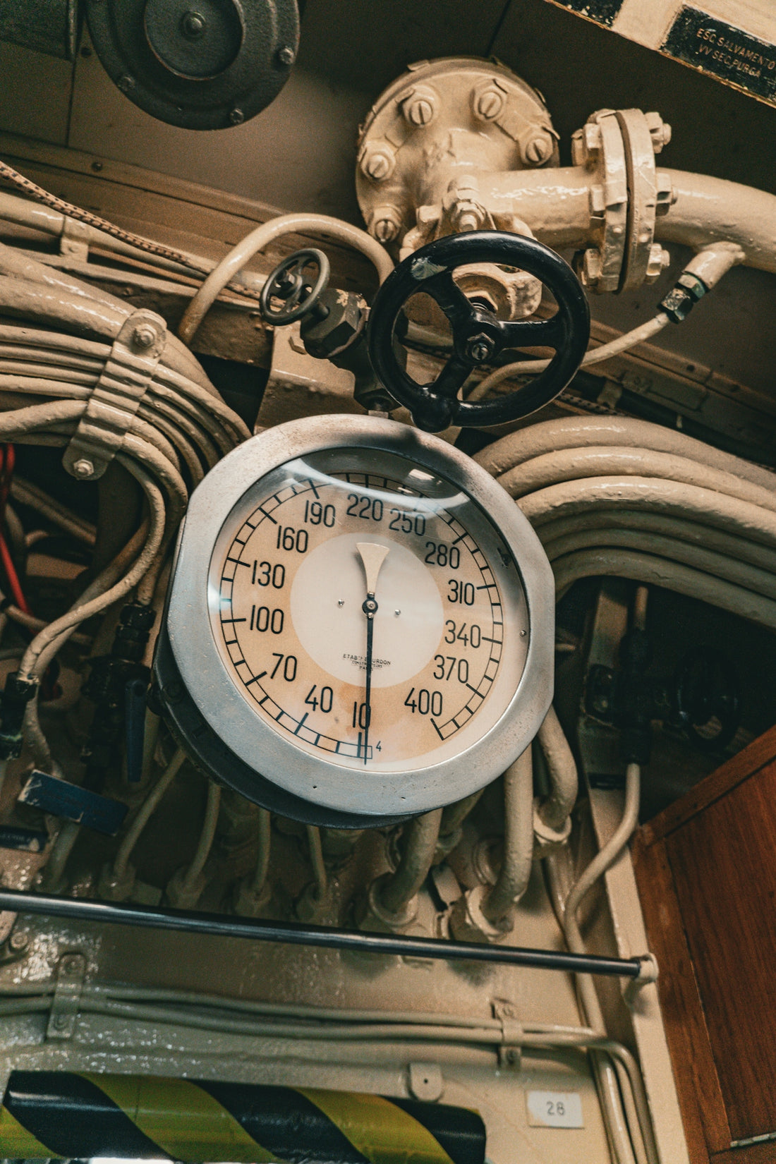 A vintage gauge and control panel are shown